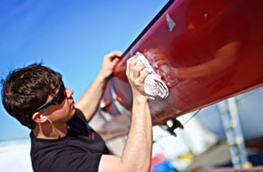 Tom Gayford waxes the mast in refit preparations