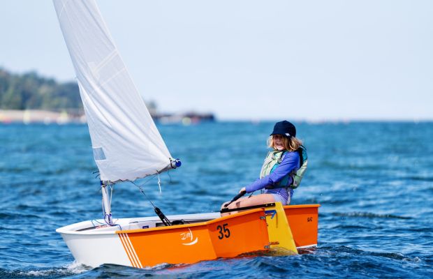orange opti sailing fast